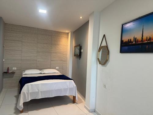 a bedroom with a bed and a tv on the wall at Maraki Suítes Maragogi 150M do Mar in Maragogi