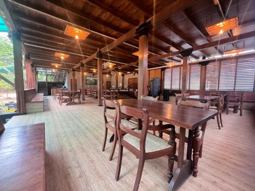 a dining room with a wooden table and chairs at Wilpattu Nature Resort in Murandanveli