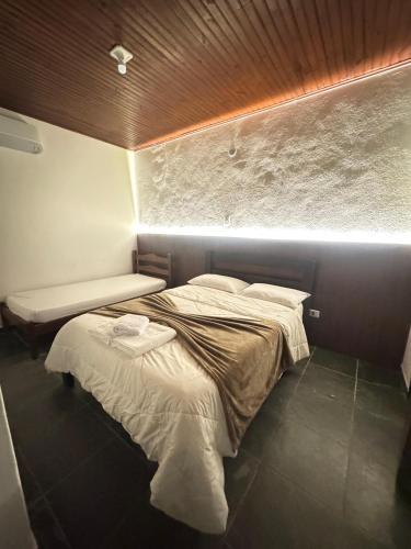 a bedroom with a large bed in a room at Pousada Barra do Sahy in Barra do Sahy