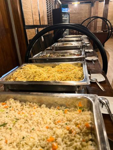 a row of trays of food on a table at Wilpattu Nature Resort in Murandanveli