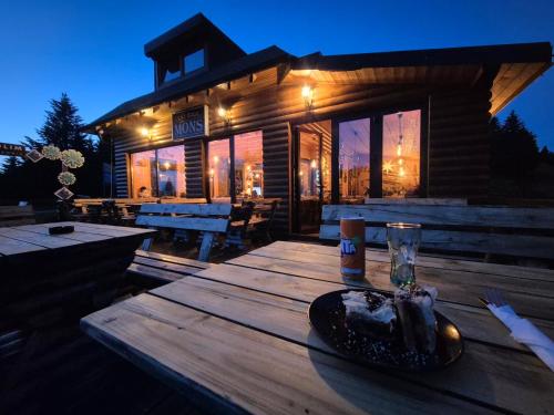 a wooden table in front of a log cabin at Milmari S70 Kopaonik in Kopaonik