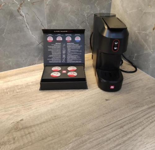 a black coffee maker sitting on a table next to a box at The View House 3 in Kithnos