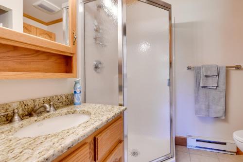 a bathroom with a sink and a shower at Pool Access Waterfront Lake Memphremagog Condo! in Newport