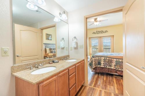 a bathroom with two sinks and a bed at Mountain View Condo 3702 in Pigeon Forge