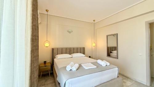 a bedroom with a bed with towels on it at Free Spirit Sophie in Kalamata