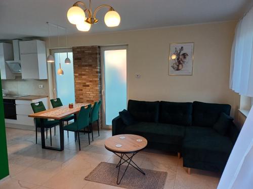 a living room with a couch and a table at Willa Przygoda in Żukowo