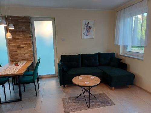 a living room with a couch and a table at Willa Przygoda in Żukowo