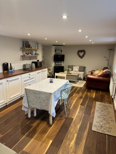 a kitchen and living room with a table and a couch at Loughanmore Court Cottage in Dundalk