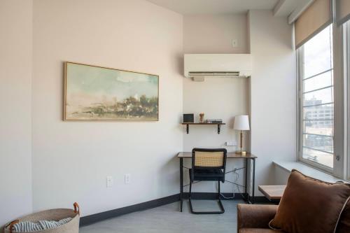 a living room with a painting on the wall at Deer District Studio Apt - One Block from Fiserv and Baird in Milwaukee