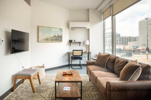 a living room with a couch and a table at Deer District Studio Apt - One Block from Fiserv and Baird in Milwaukee