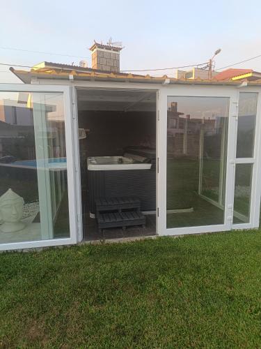 a screened in porch with a hot tub inside at sand and sea in Póvoa de Varzim