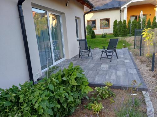a patio with chairs and plants in front of a house at Willa Przygoda in Żukowo