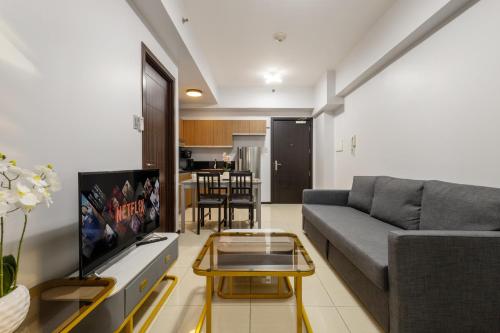 a living room with a couch and a tv at The Radiance Manila Bay in Manila