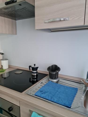 a kitchen with a stove with a blue towel on it at La dolce vita in Pescara