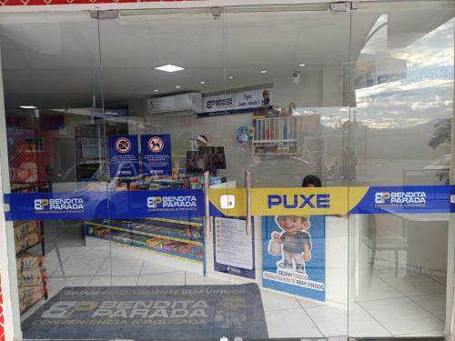 a store with a pike sign in the window at Bendita Parada - Pousada in Sobral