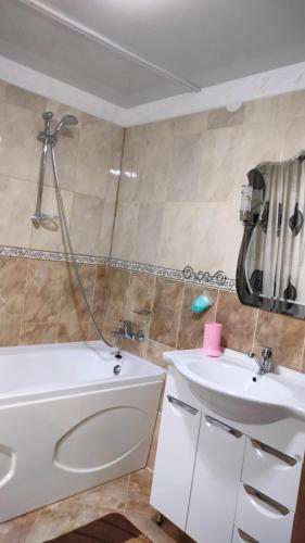 a bathroom with a sink and a tub and a toilet at Садиба Трембіта in Pilipets