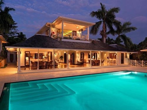 an exterior view of a house with a swimming pool at Round Hill Hotel & Villas in Montego Bay