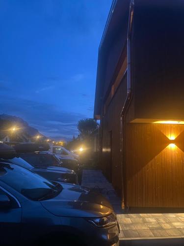 a row of cars parked next to a building at night at KopfRausch Appartements in Feldkirch