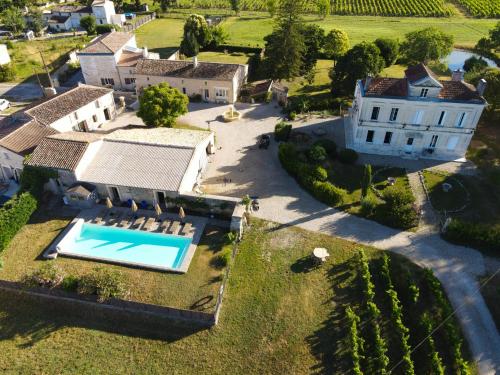 an aerial view of a large estate with a swimming pool at Château Clos des Maurins in Vérac