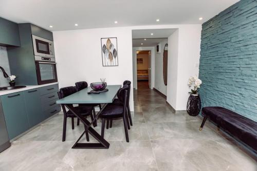 a kitchen and dining room with a table and chairs at Aria in Cetinje