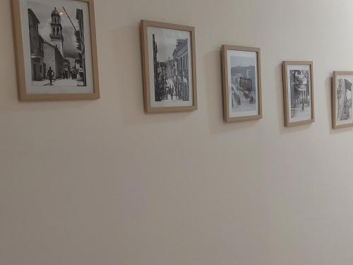 a group of framed photographs on a wall at Rouchotas Studios by Viktor 1rst Floor in Argostoli