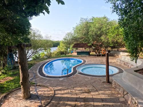 a swimming pool in the middle of a yard at Wilpattu Nature Resort in Murandanveli