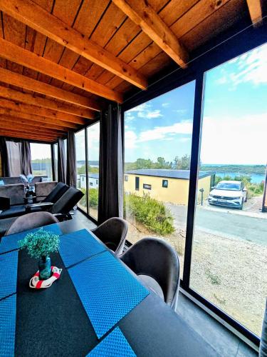 a dining room with a table and chairs and a large window at Sea view BluEscape by Vellaris, Luxury Mobile Home in Mali Lošinj