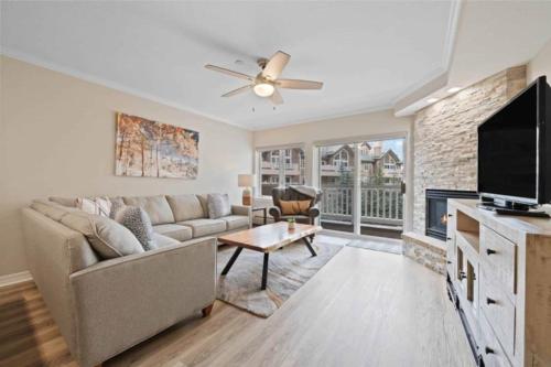 a living room with a couch and a fireplace at St James Place 216 in Beaver Creek