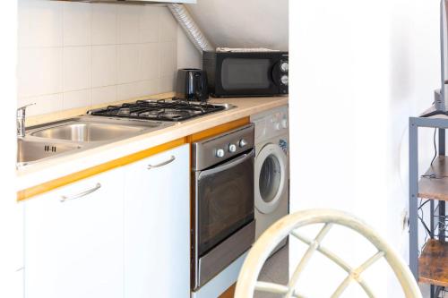 a kitchen with a sink and a stove at Altair in Agrustos