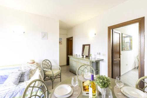 a living room with a bed and a table and chairs at Altair in Agrustos