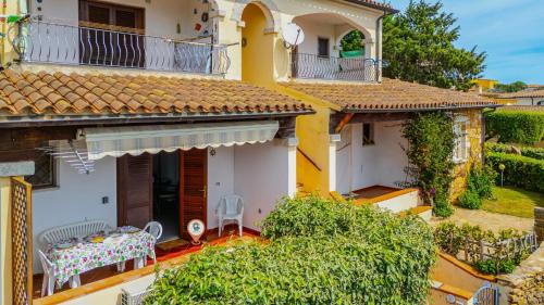 a house with a table and chairs on the balcony at Altair in Agrustos