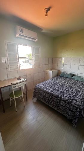 a bedroom with a bed and a desk and a desk at Elite Hotel 02 in Teresina