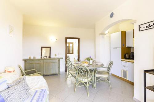 a kitchen and dining room with a table and chairs at Altair in Agrustos