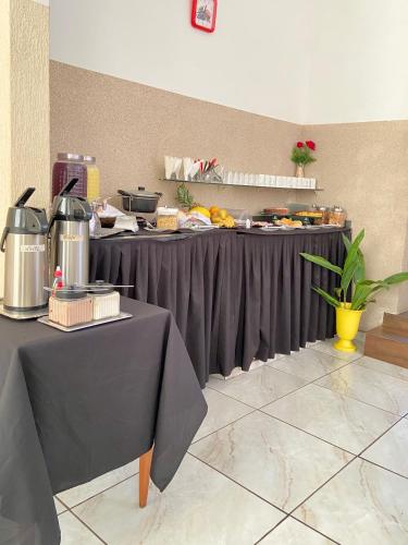 a table with food on it in a room at Hotel Avenida Bauru in Bauru