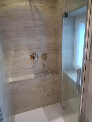 a shower with a shower head in a bathroom at Casa Giovy in Roccastrada