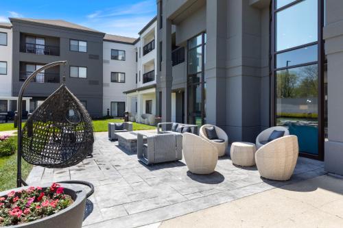 a courtyard with chairs and a building at Best Western Plus Elgin - Chicago in West Dundee