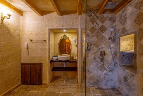 a bathroom with a shower and a sink at Lagoon Cave Suites in Urgup