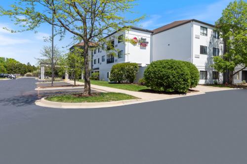 a white building with a tree in the street at Best Western Plus Elgin - Chicago in West Dundee