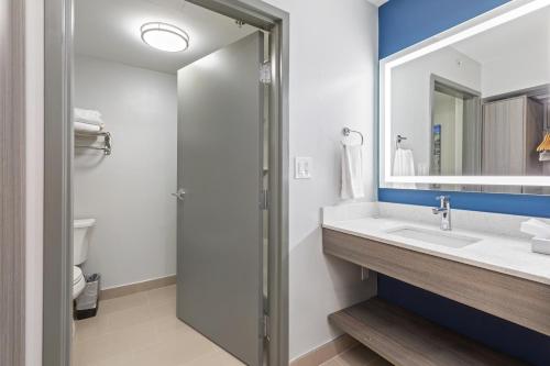 a bathroom with a sink and a mirror at Best Western Plus Elgin - Chicago in West Dundee