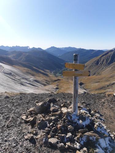 a wooden sign on the top of a mountain at Le flocon in Allos