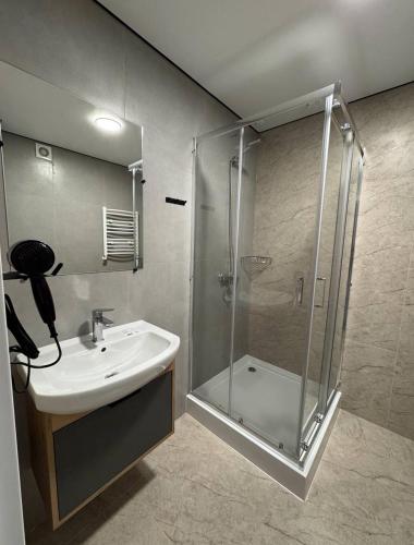 a bathroom with a shower and a sink at Hotel Hostel Перехрестя in Chistilov