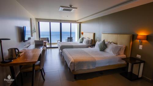 Postel nebo postele na pokoji v ubytování Hotel Poseidon