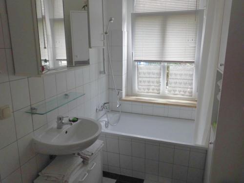 a bathroom with a sink and a bath tub at 2 Norit Schlosser Comfortable holiday residence in Heidenau