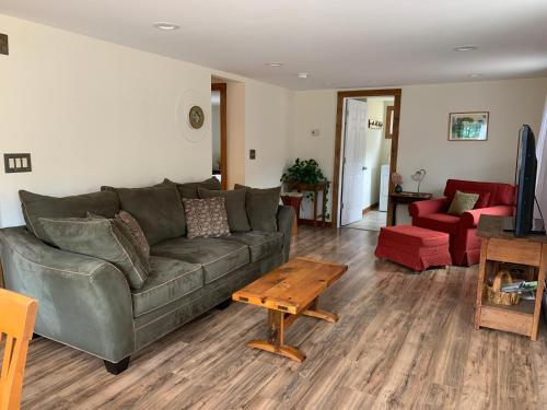 un salon avec un canapé et une table basse dans l'établissement Green River Cottage, à Guilford