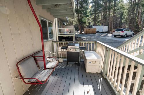 a porch with a bench and a grill on a house at RR-Birch_Creek 2 in June Lake