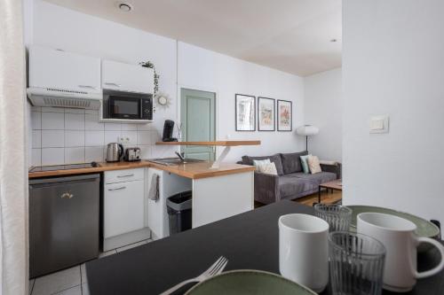 une cuisine et un salon avec une table et des chaises dans l'établissement La Dolce Notte - Calme & central, tout à pied, à Nantes