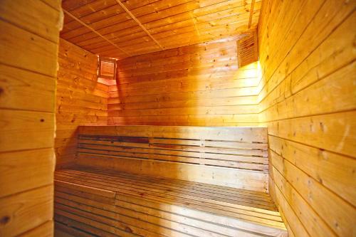 a wooden sauna with a bench in the middle at Solna Chata-dom na wyłączność Grota solna, balia, sauna, basen in Rajcza