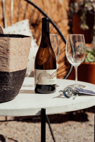 a bottle of wine and a glass on a table at Campera Valle de Guadalupe in Ensenada