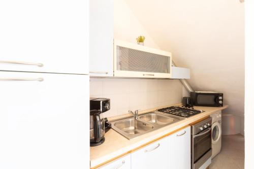a small kitchen with a sink and a microwave at Altair in Agrustos