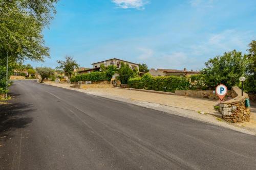 an empty street with a street sign in front of houses at Altair in Agrustos